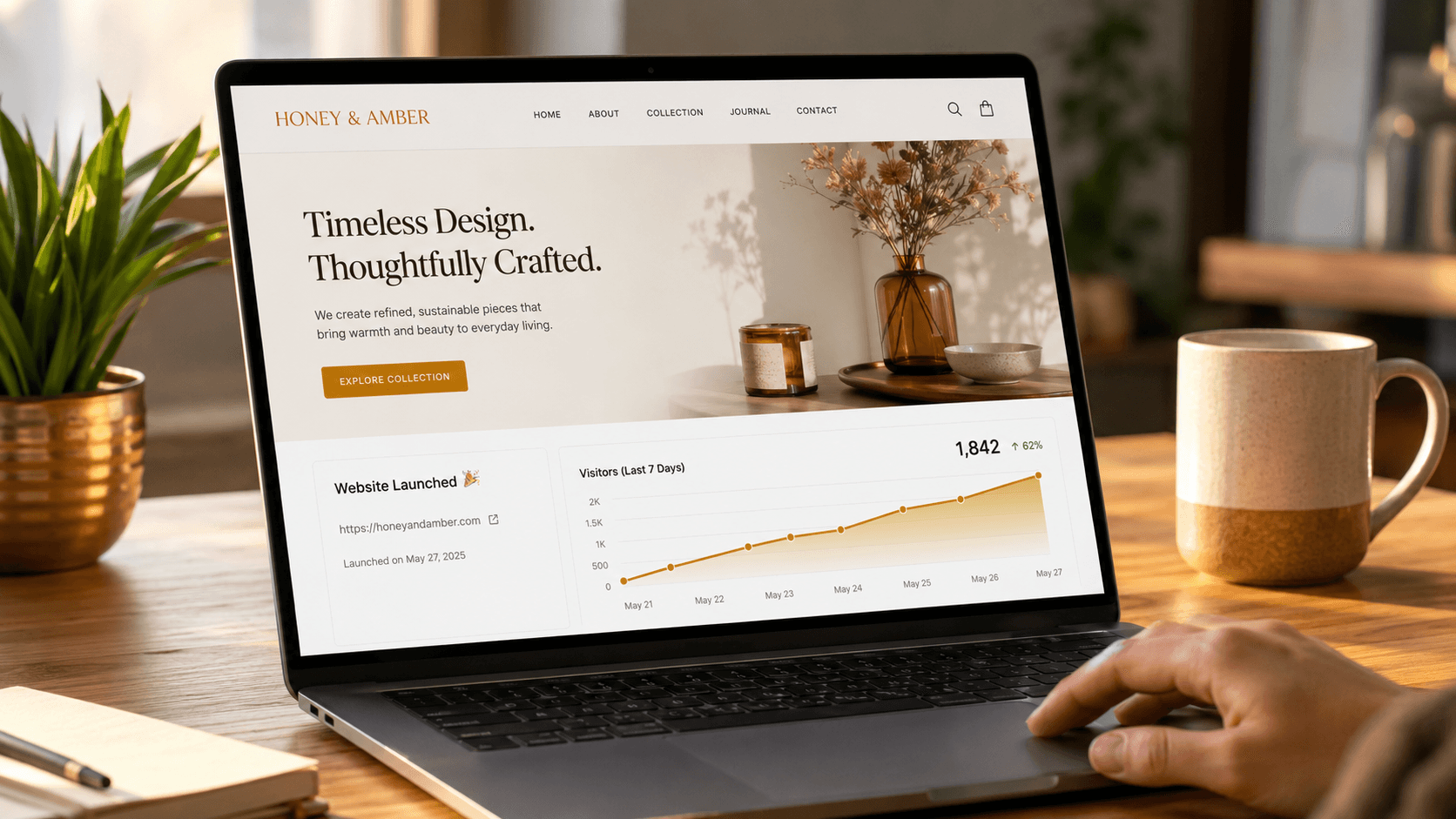 A laptop showing a freshly launched website with a visitor analytics graph trending up